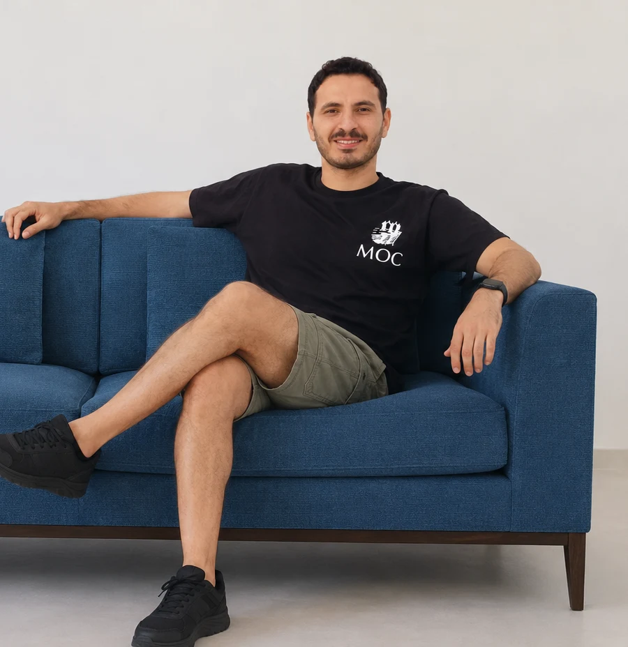 A man relaxing on a deep blue Grees& sofa
