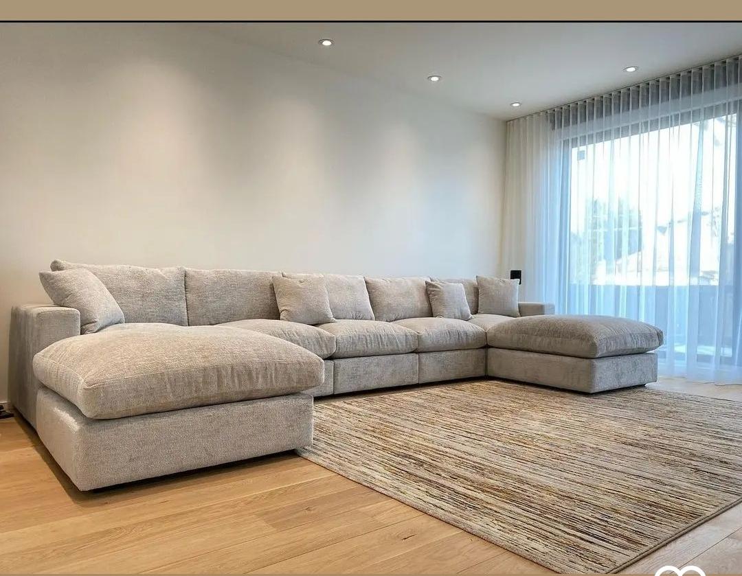 A large grey modular sectional sofa delivered in New Cairo